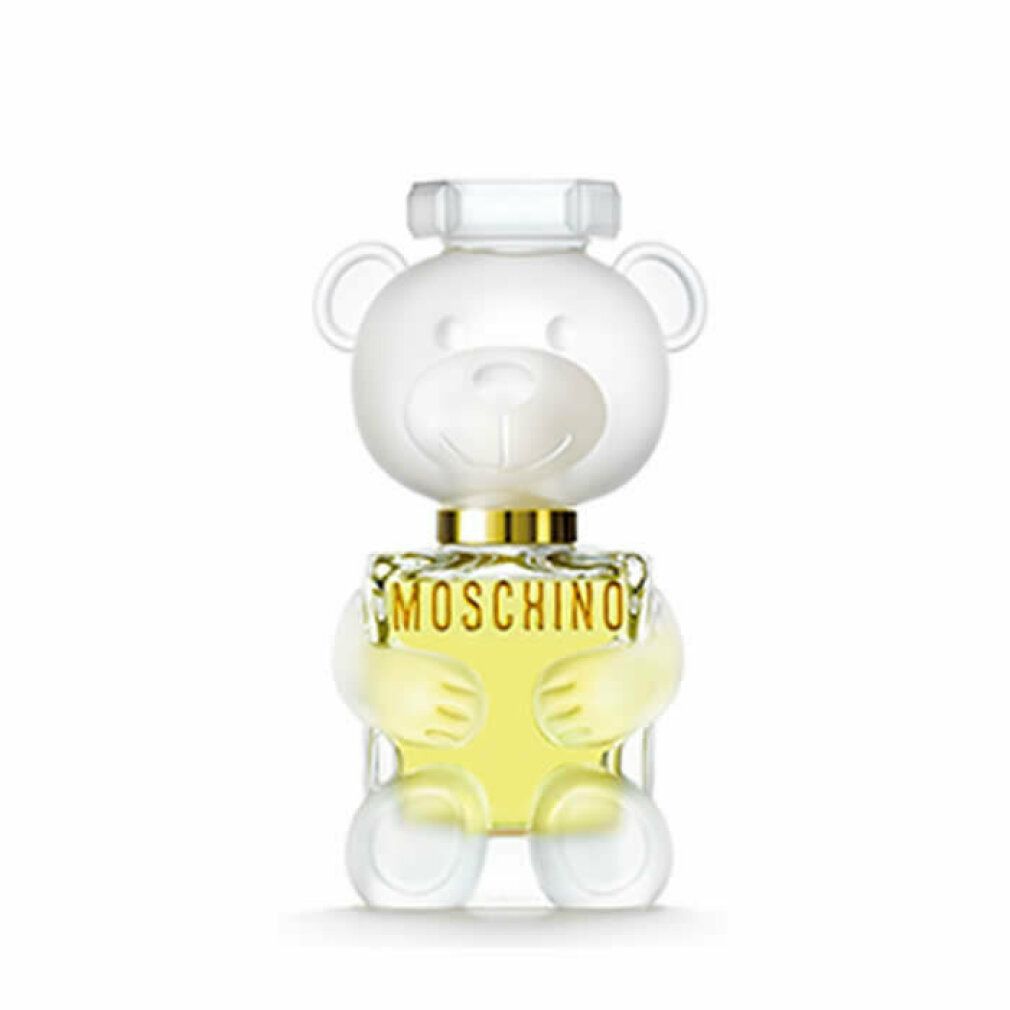 Flacone di profumo a forma di orsetto. Design trasparente con collare dorato. Scritta: MOSCHINO.