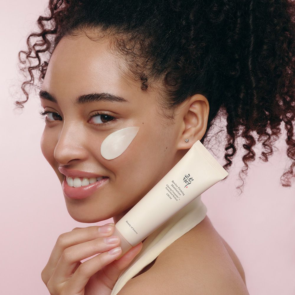Donna con tubo Revive Firming Moisturizer e crema