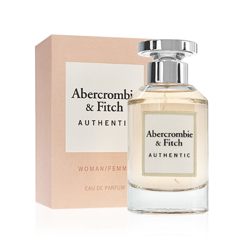 Flacone di profumo e confezione. Flacone con tappo argentato, liquido chiaro. Confezione con logo e testo.