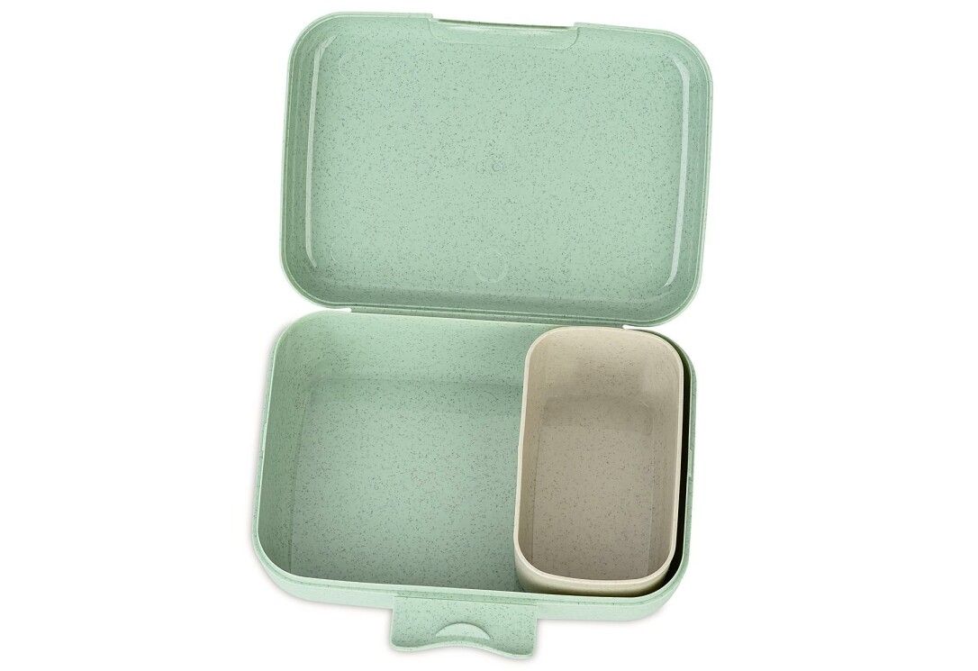 Lunch box verde aperta. Forma rettangolare con contenitore separato. Plastica. Interno beige.