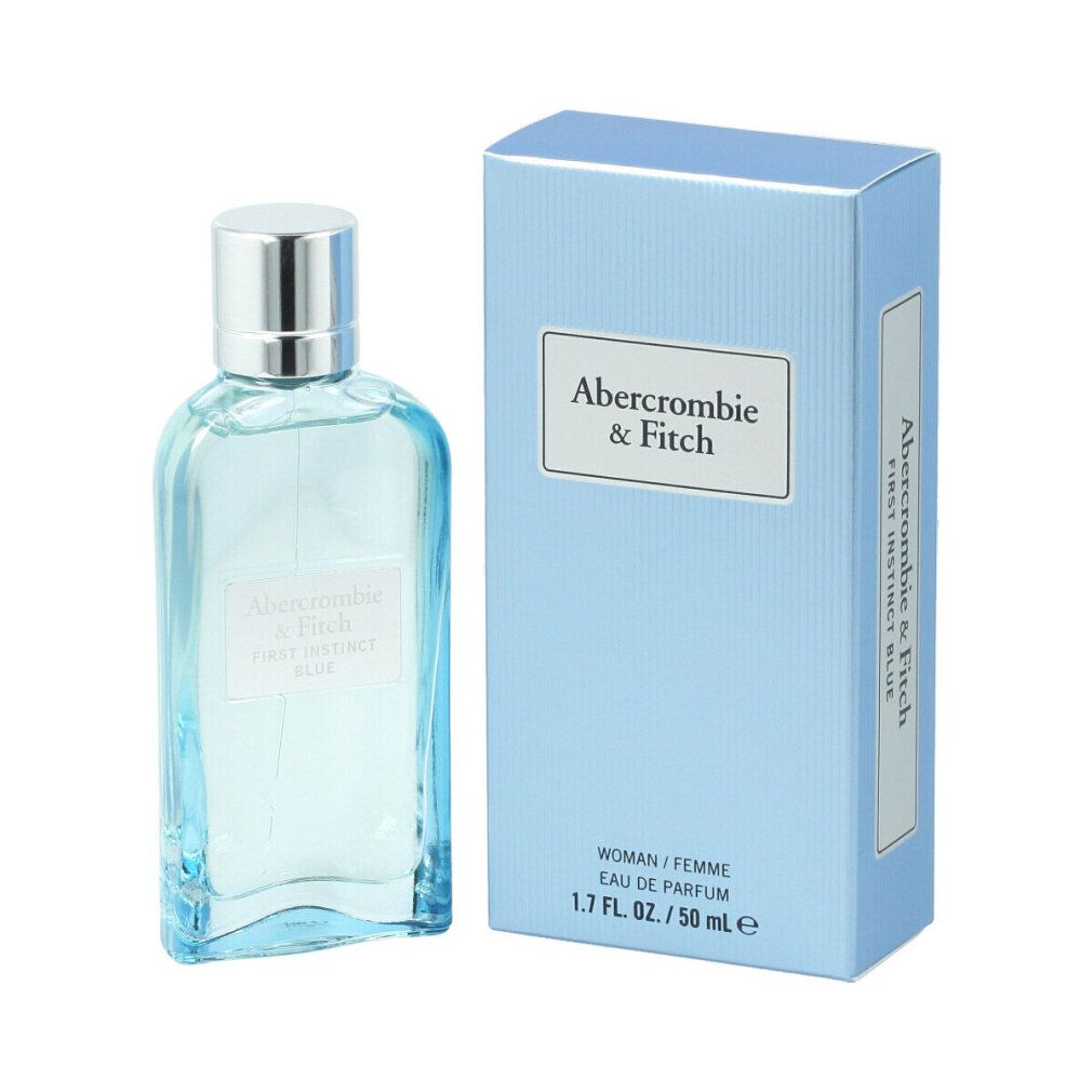 Flacone di profumo azzurro chiaro e scatola. Scritta: Abercrombie & Fitch, First Instinct Blue. Flacone con tappo argentato.