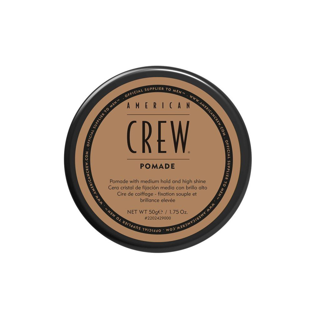 Barattolo rotondo con coperchio nero ed etichetta marrone. Scritta: AMERICAN CREW POMADE. Testo multilingue.