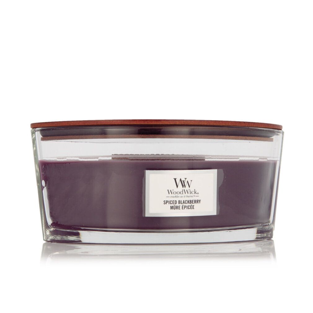 Candela Ellipse con coperchio in legno. Cera viola in contenitore di vetro. Etichetta "Spiced Blackberry". Logo WW.