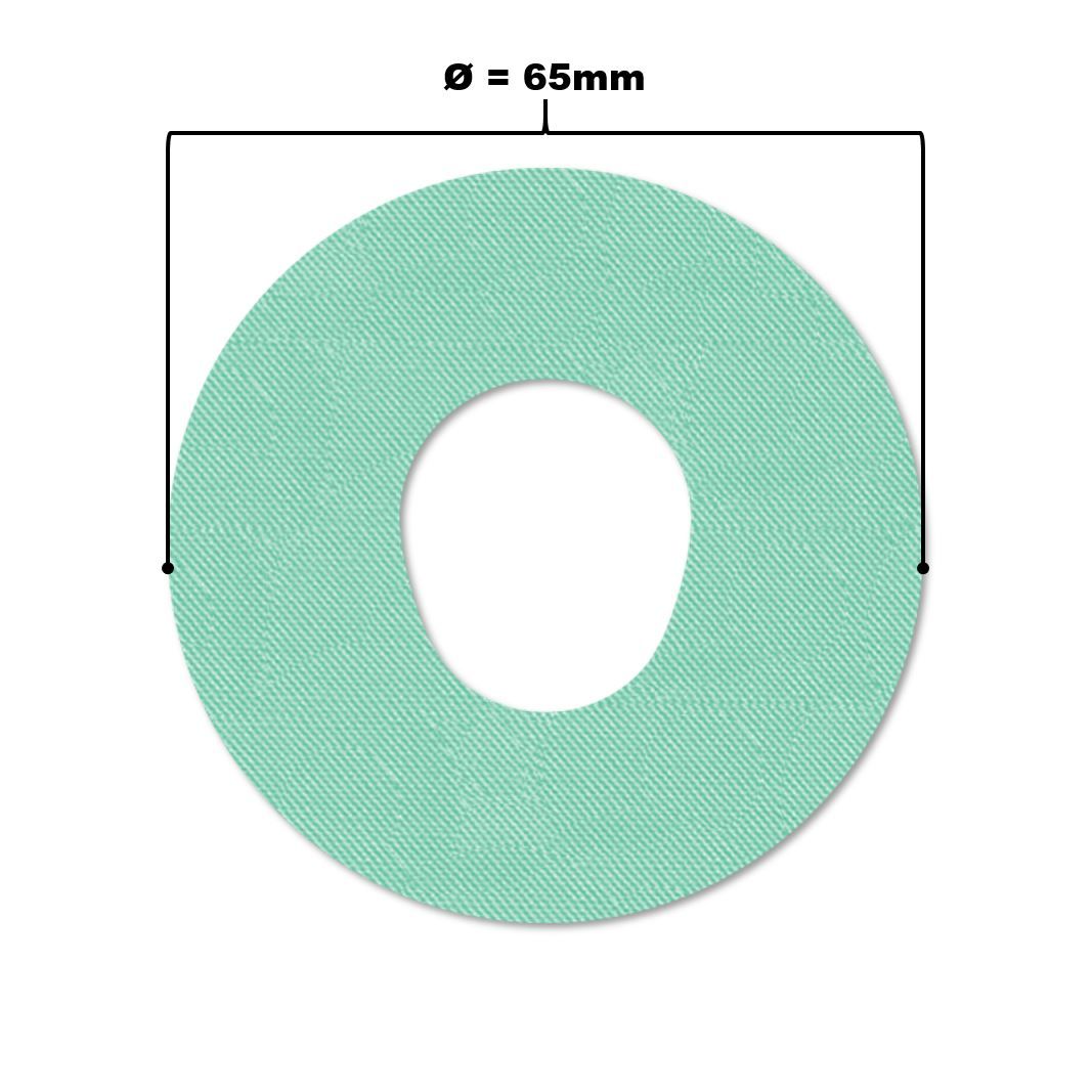 Cerotto di fissaggio rotondo verde chiaro con foro centrale. Diametro 65mm. Linea nera con misura.