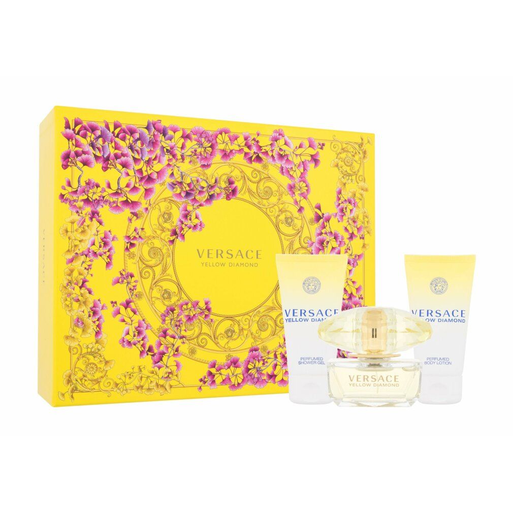 Set regalo giallo Versace con flacone, due tubi e scatola con elementi floreali.
