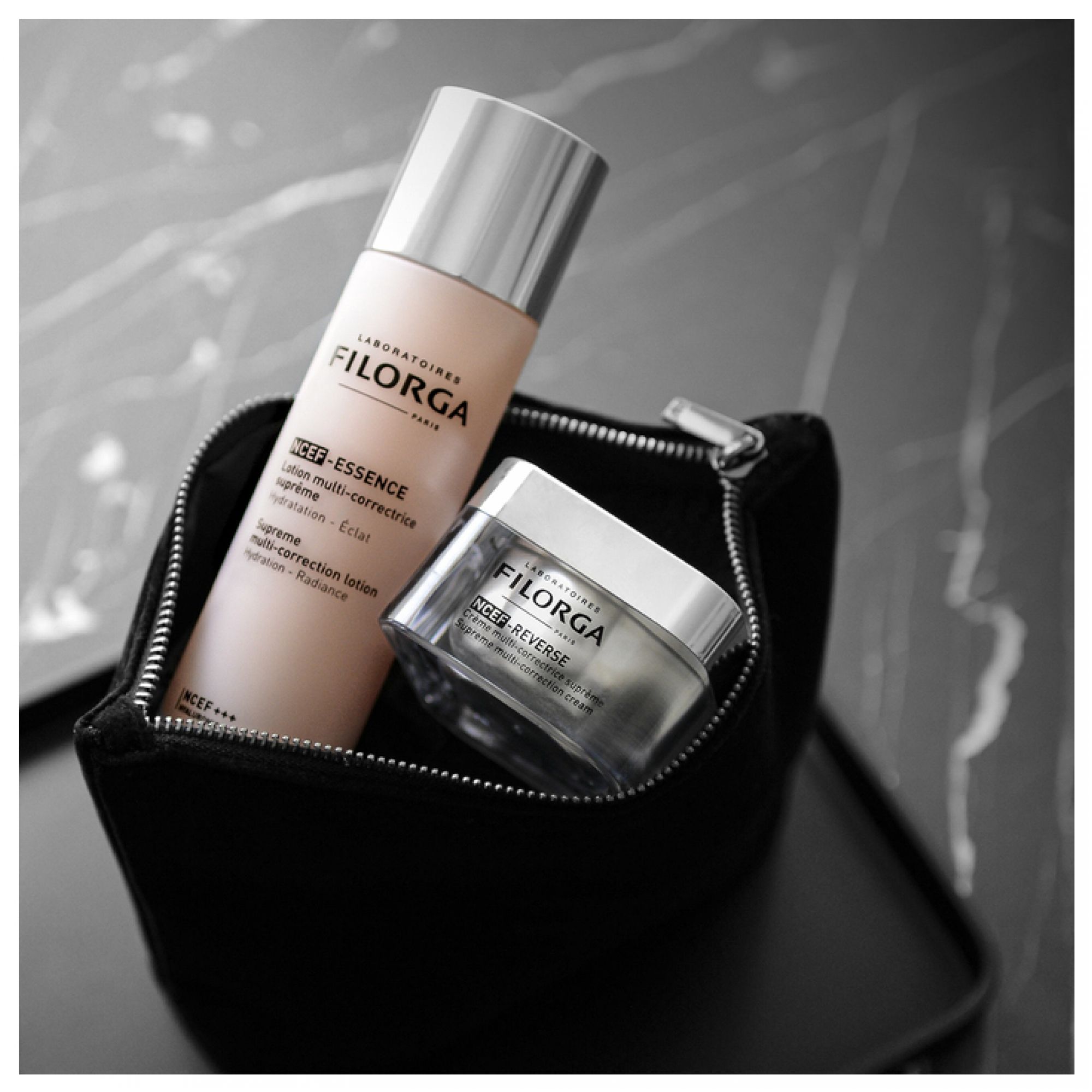 Lozione Filorga NCEF Essence e crema NCEF-Reverse in un beauty case nero.