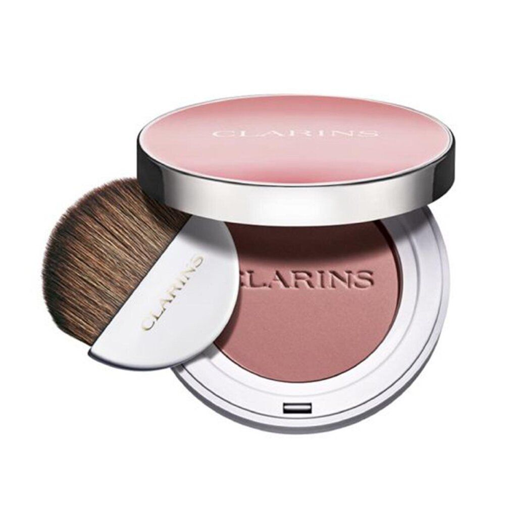 Fard in polvere compatto rotondo con pennello. Coperchio con scritta CLARINS. Polvere rosa. Pennello con manico bianco. Scritta CLARINS.