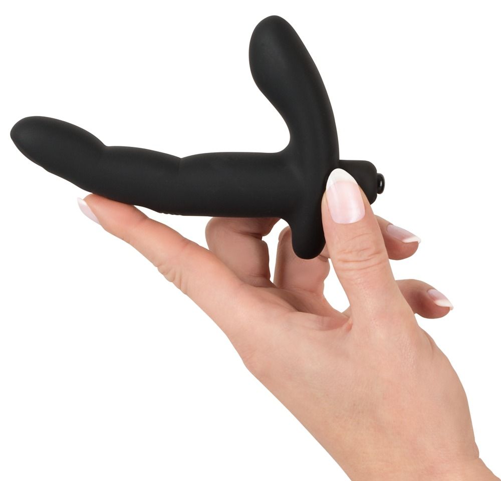 Vibratore nero tenuto in mano. Composto da un'asta allungata e una parte curva. Base arrotondata.