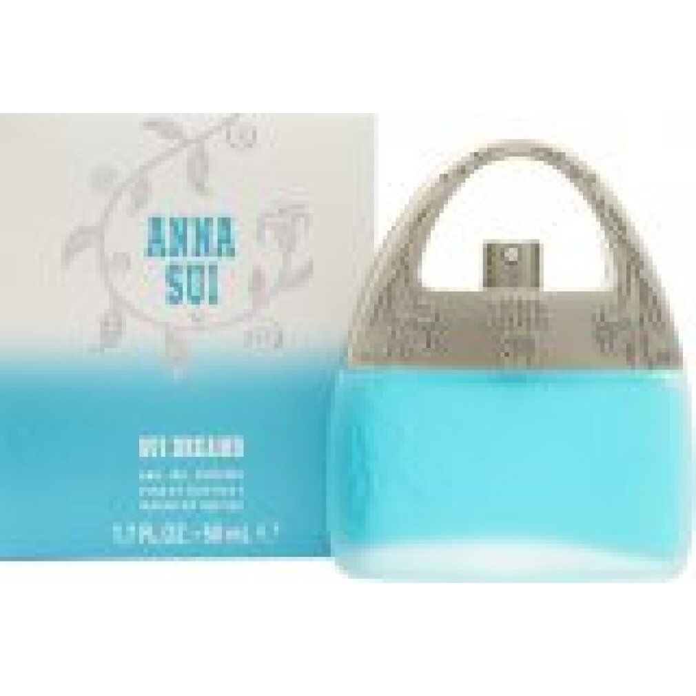 Anna Sui Sui Dreams Eau de Toilette Spray. Flacone e confezione. Profumo azzurro a forma di borsetta. Confezione con testo.