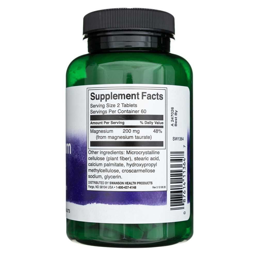 Flacone verde di integratori, etichetta con "Supplement Facts" e dettagli sul magnesio.
