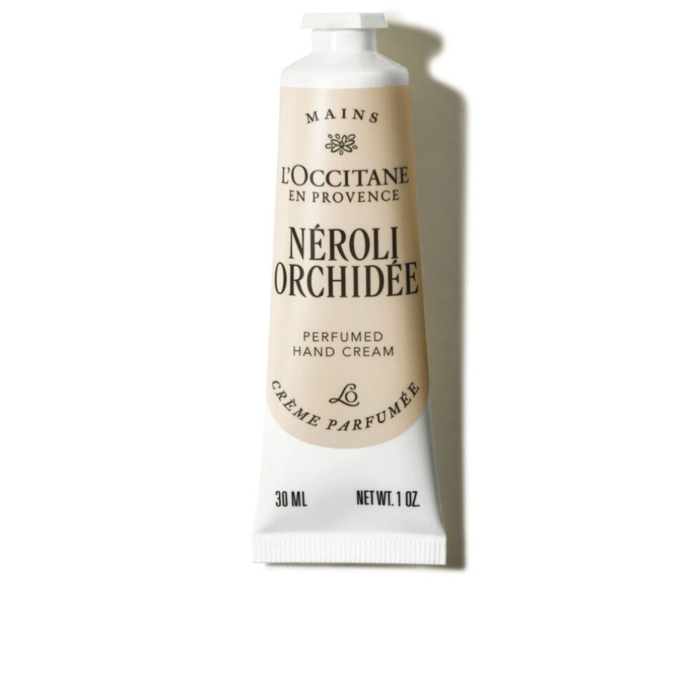 Tubo crema. L'Occitane Neroli & Orchidée. Tubo beige e bianco con tappo a vite. Testo: Neroli Orchidée, 30 ml, 1 oz.