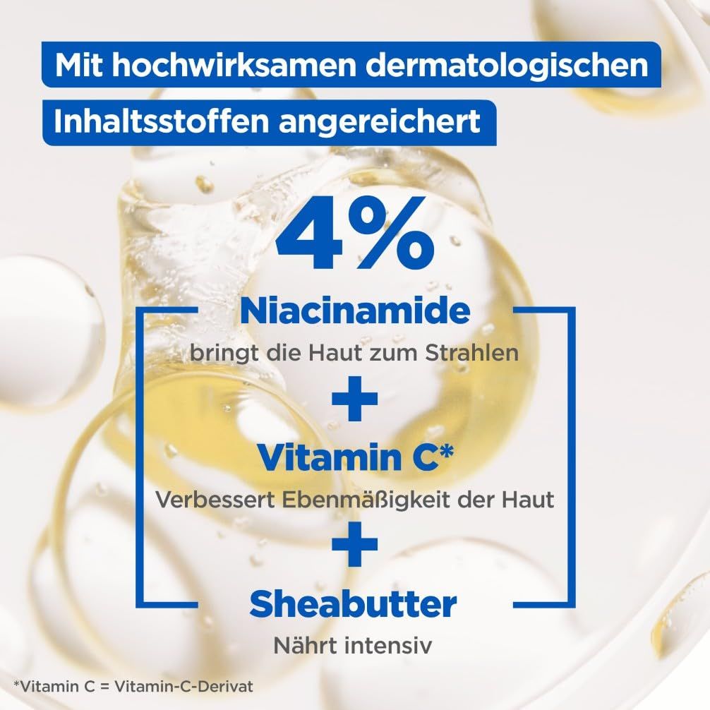 Primo piano di gocce di liquido. Testo: 4% Niacinamide, Vitamina C, Burro di karité.