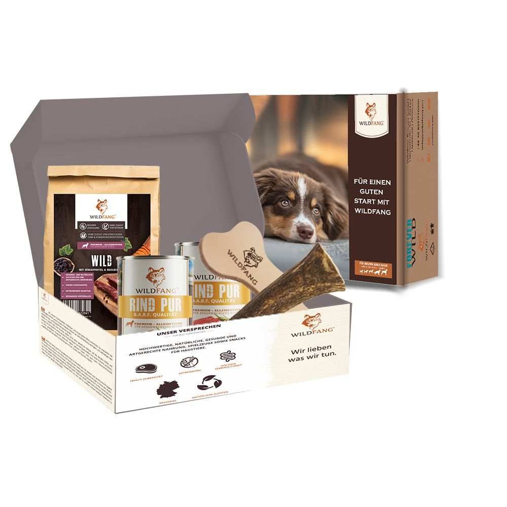 Confezione regalo aperta con cibo per cani, masticabili e accessori. Contiene: sacchetto di cibo, cibo in scatola, giocattolo da masticare a forma di osso, corna di cervo. Logo Wildfang. Scritta: Per iniziare bene con Wildfang.