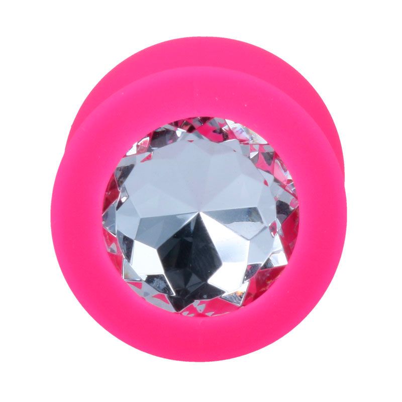 Vista dall'alto di un plug anale rosa con decorazione in cristallo. Base rotonda con pietra preziosa. Superficie liscia.