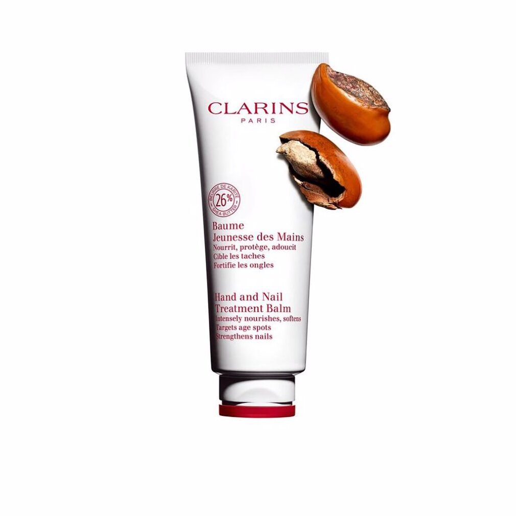 Tubo bianco con tappo rosso. Testo: Clarins, Baume Jeunesse des Mains, Hand and Nail Treatment Balm. Grafica rotonda con 26%. Due noci.