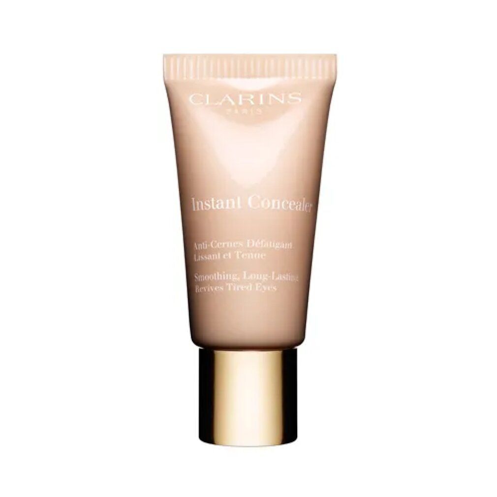 Tubo beige con tappo dorato. Scritta: Clarins, Instant Concealer. Testo: Anti-Cernes Défatigant, Lissant et Tenu, Revives Tired Eyes.