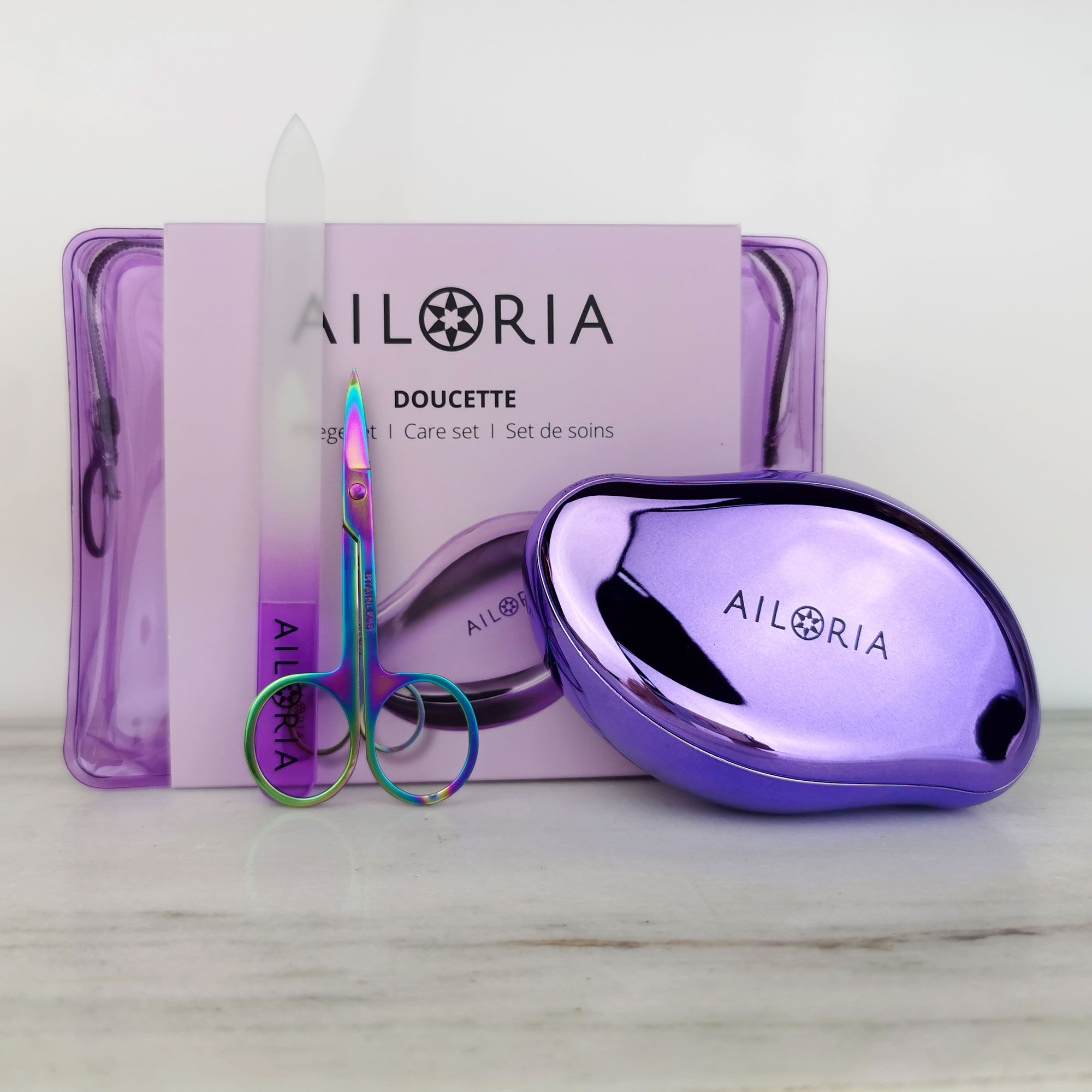 Set con lima per piedi, forbici per unghie e lima in vetro. Logo AILORIA. Borsa trasparente. Nome prodotto: DOUCETTE.