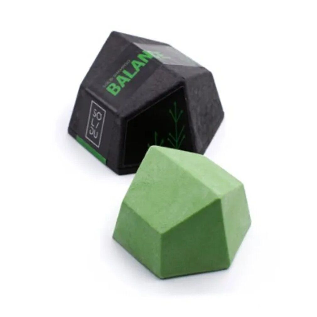 Barra shampoo verde geometrica e confezione nera con testo verde. Marchio SOL/DU e BALANCE.