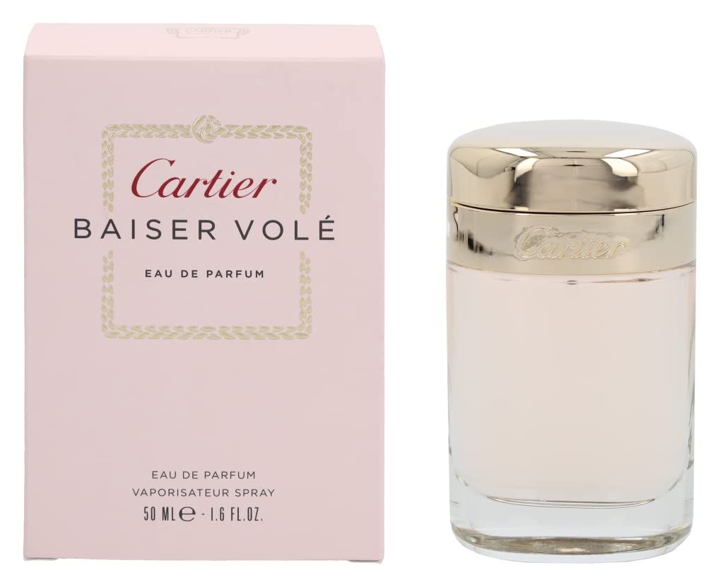 Flacone di profumo e confezione. Flacone in vetro con tappo dorato. Confezione rosa con scritta Cartier Baiser Volé.