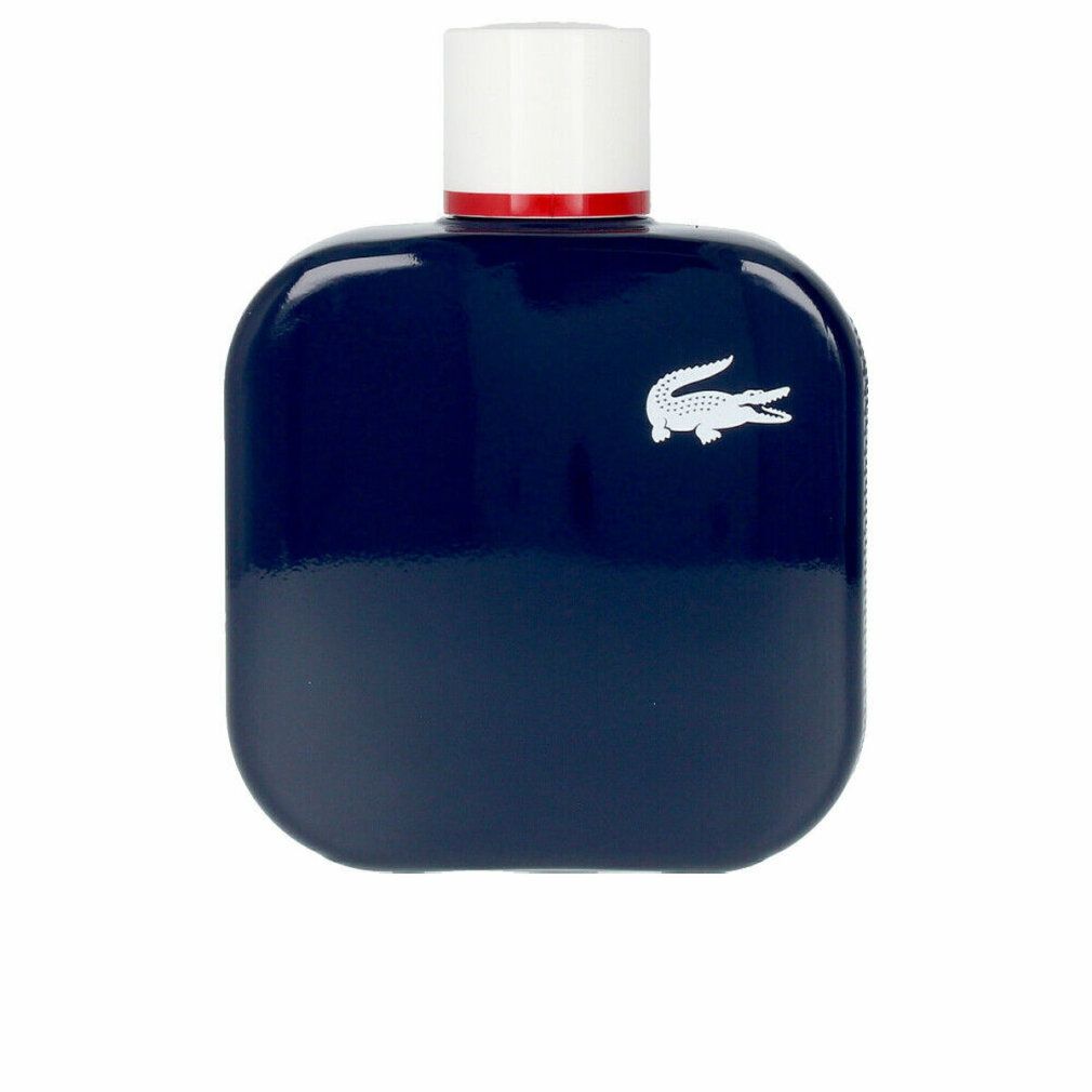 Flacone blu scuro con tappo bianco e anello rosso. Logo coccodrillo bianco. Forma quadrata con angoli arrotondati.