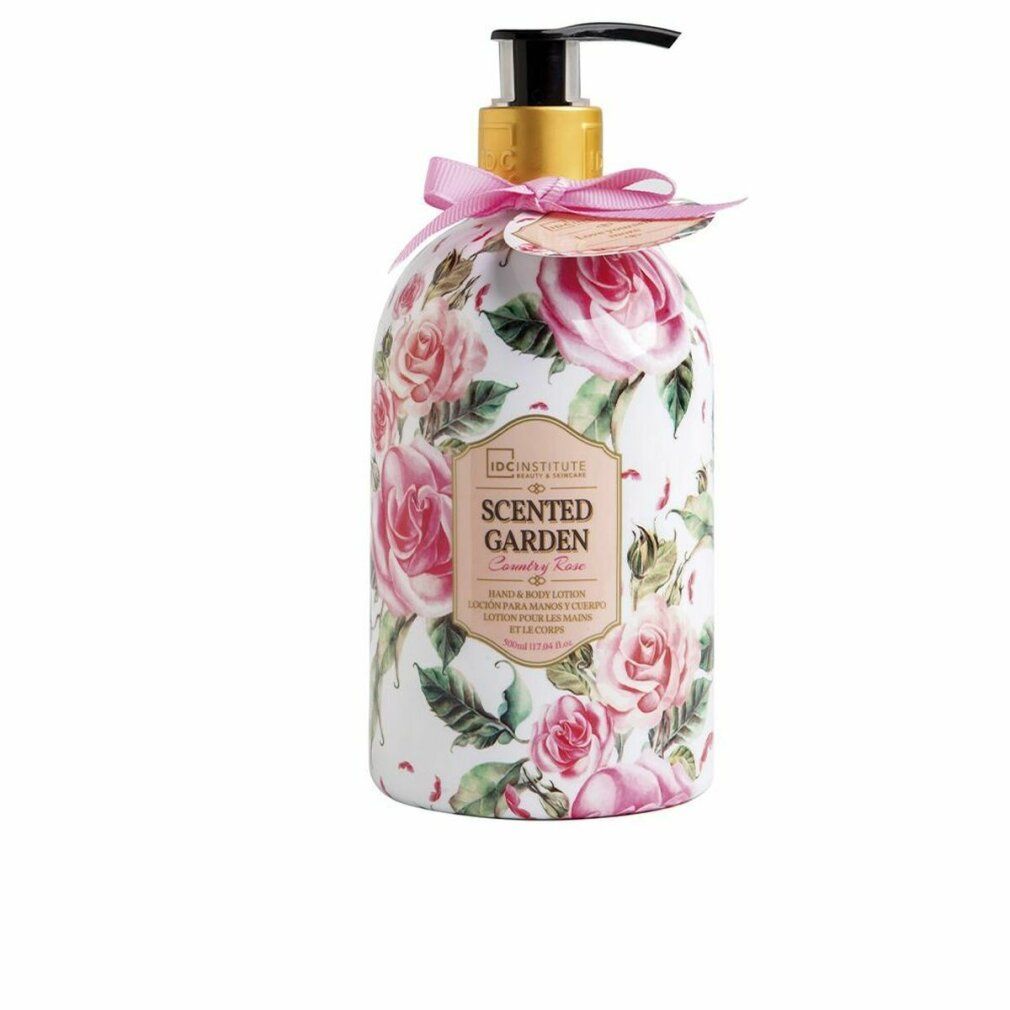 Flacone con motivo floreale e dosatore. Scritta: Scented Garden, Rose. Fiocco rosa ed etichetta.