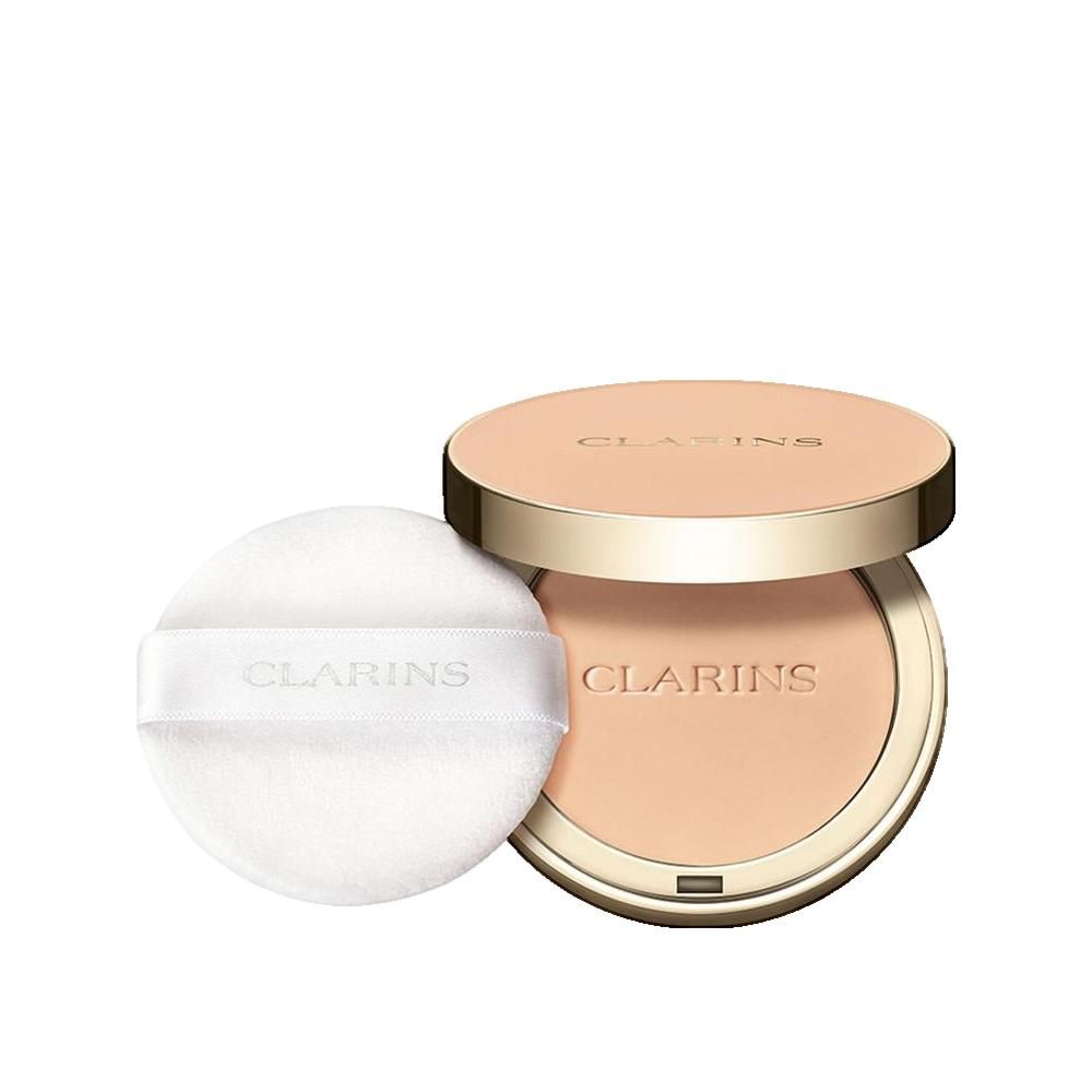 Cipria compatta con specchio e applicatore. Coperchio dorato con scritta. Cipria in tonalità chiara. Applicatore con nastro e scritta.