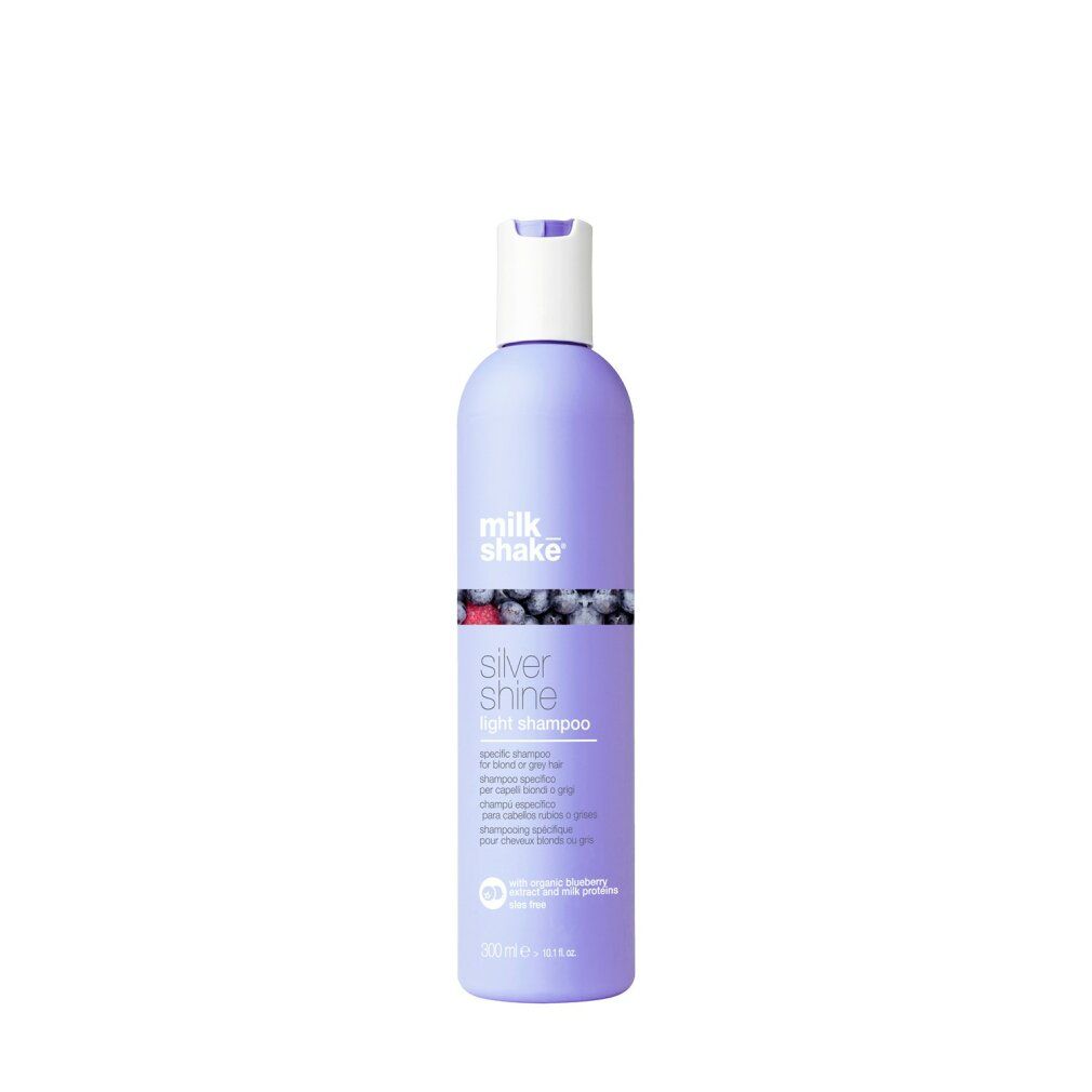 Flacone di shampoo viola, tappo bianco. Scritta: milk_shake, Silver Shine light shampoo. Con mirtillo e proteine del latte.