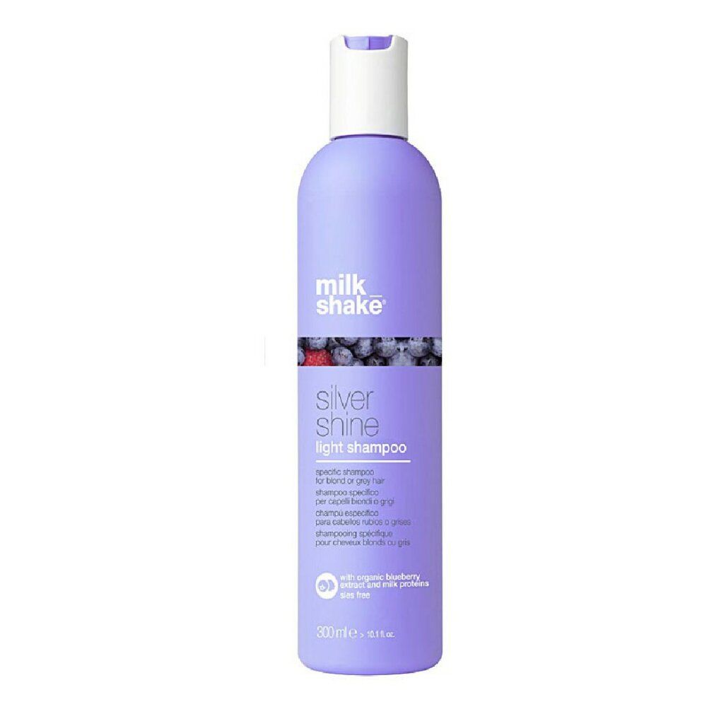 Flacone di shampoo viola, tappo bianco. Scritta: milk_shake, Silver Shine light shampoo. Con mirtillo e proteine del latte.