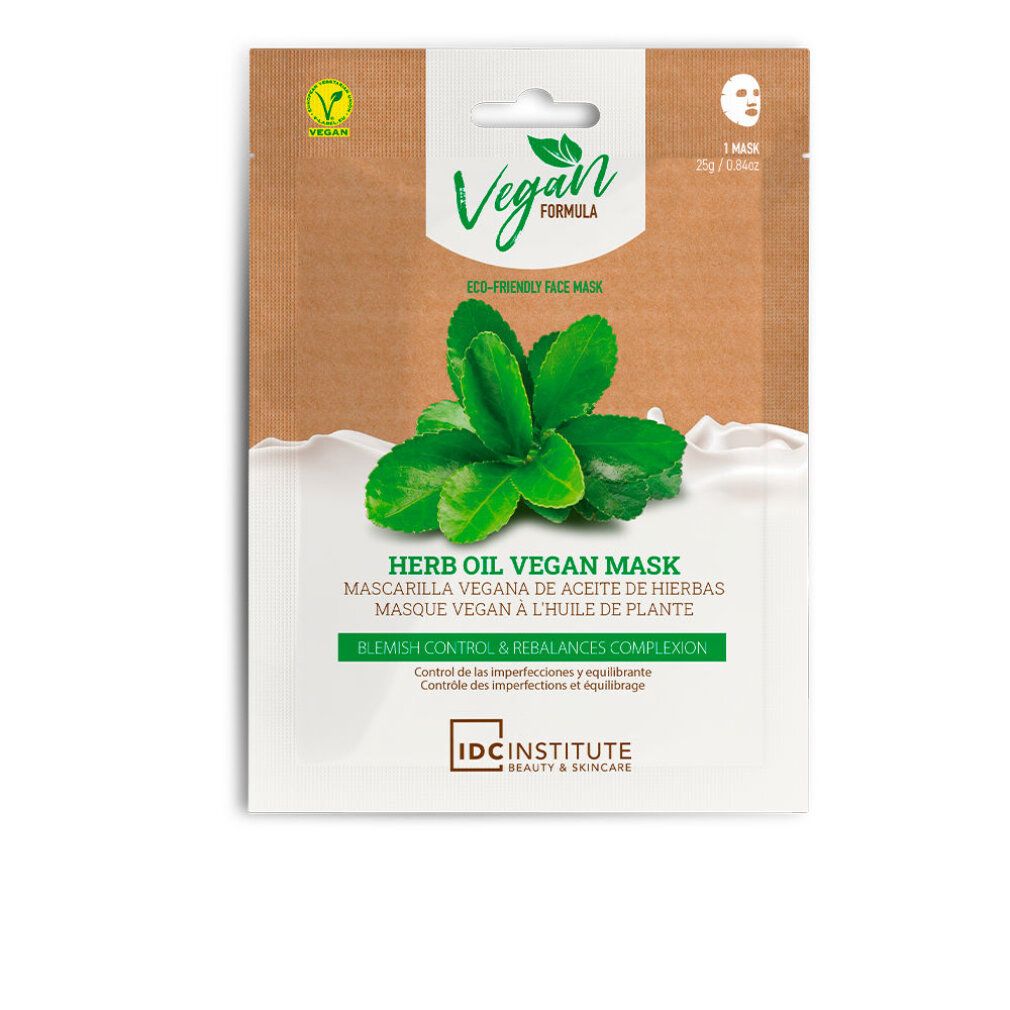Maschera viso con foglie verdi e testo. Logo vegano. Testo: Herb Oil Vegan Mask, Blemish Control & Rebalances Complexion. Marchio: IDC Institute.