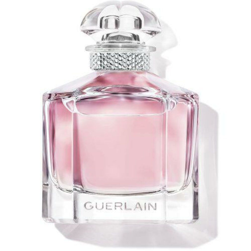 Flacone in vetro con liquido rosa. Tappo trasparente. Anello argentato attorno al collo. "GUERLAIN" in basso.