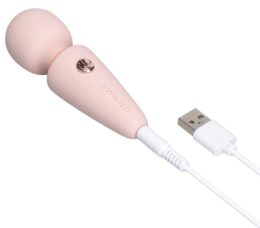 Un piccolo vibratore bianco con testa sferica e manico conico, tenuto in una mano.