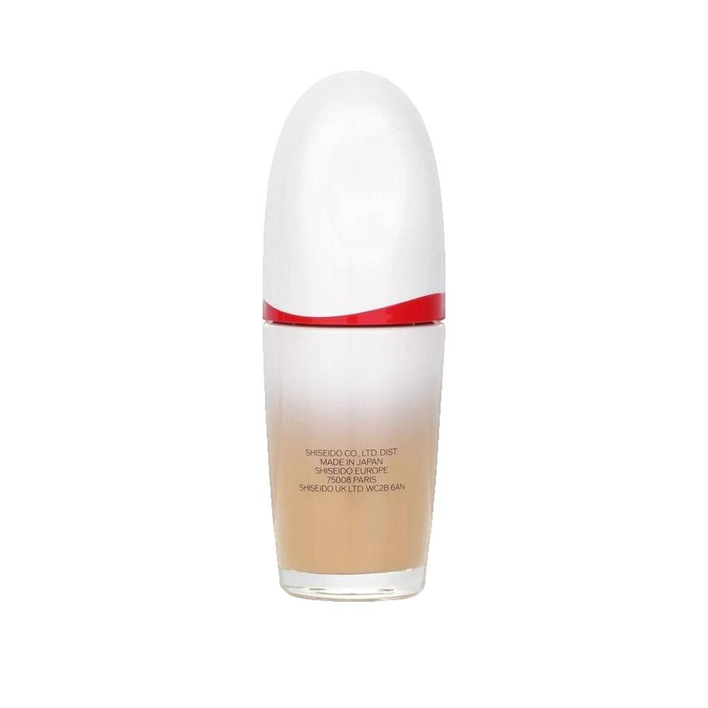Shiseido FT Revitalessence Skin Glow. Flacone, retro. Design bianco e rosso. Testo: Made in Japan, Shiseido Co., Ltd., Paris. Sfumatura beige a bianco.