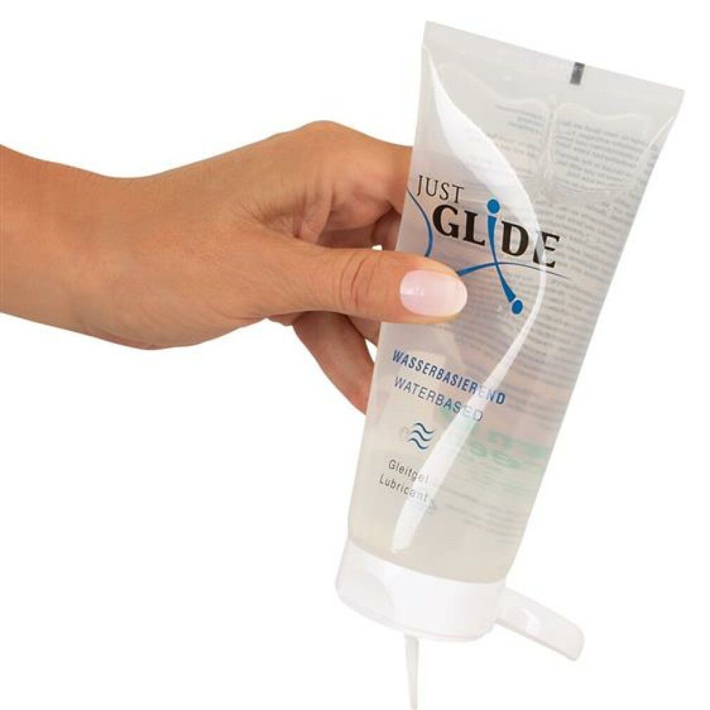 Mano che tiene un tubo. Gel che fuoriesce. Scritta: JUST GLIDE, a base d'acqua, gel lubrificante.