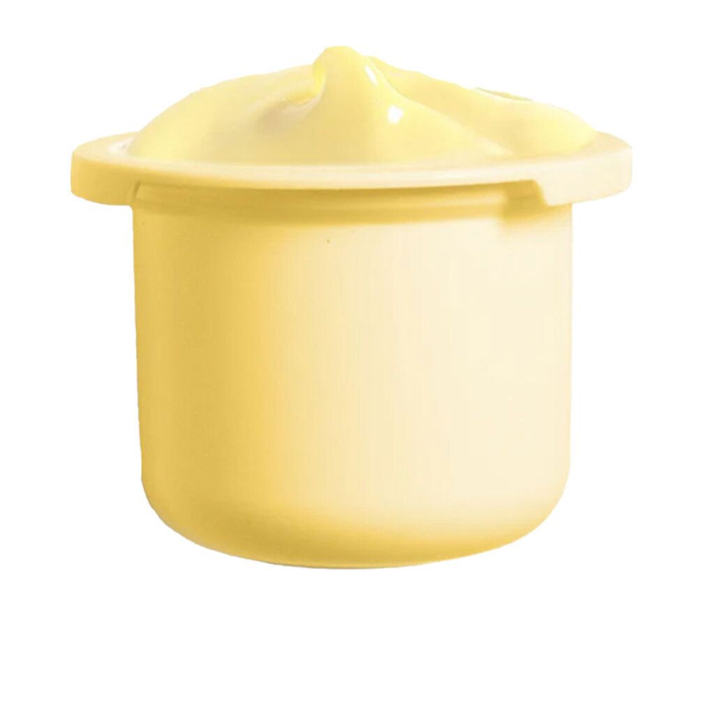 Crema giallastra in un piccolo contenitore rotondo. Il contenitore ha un bordo largo. La crema è bombata.