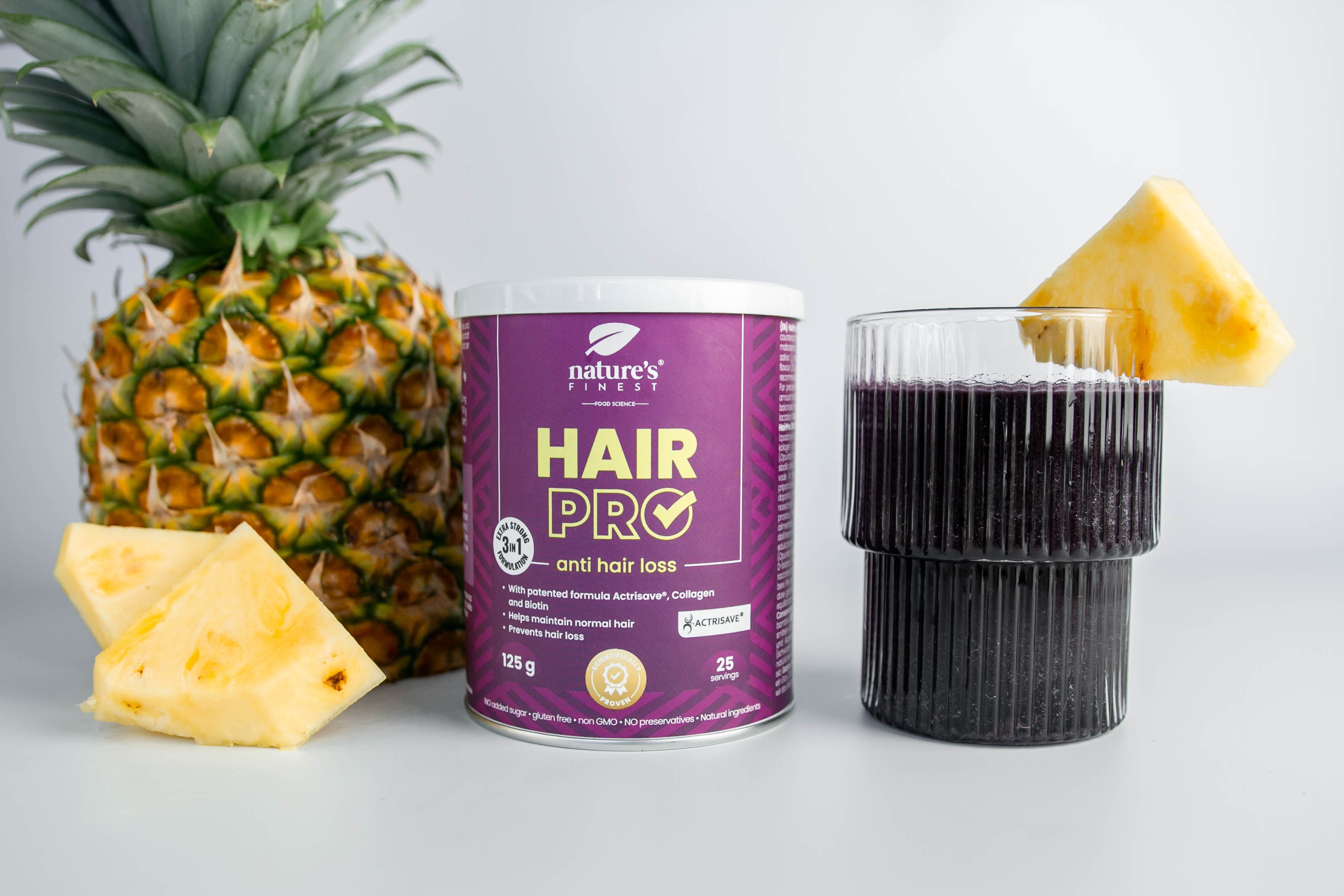 Barattolo Nature's Finest Hair Pro, ananas, bicchiere con bevanda. Scritta: Hair Pro, contro la caduta dei capelli. 125g, 25 porzioni.