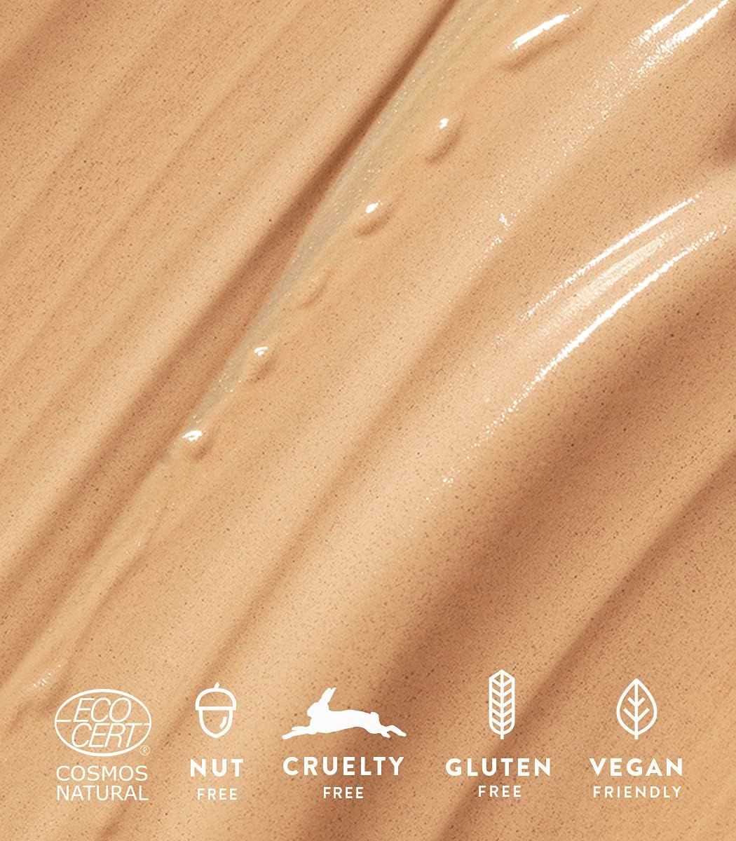 Primo piano di crema con loghi: Cosmos Natural, Nut Free, Cruelty Free, Gluten Free, Vegan Friendly.