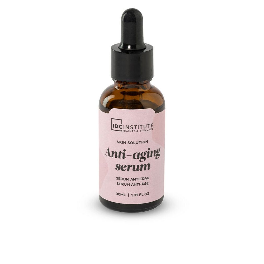 Flacone di vetro marrone con contagocce nero. Etichetta rosa con testo: Anti-aging serum. Marchio: IDC INSTITUTE.