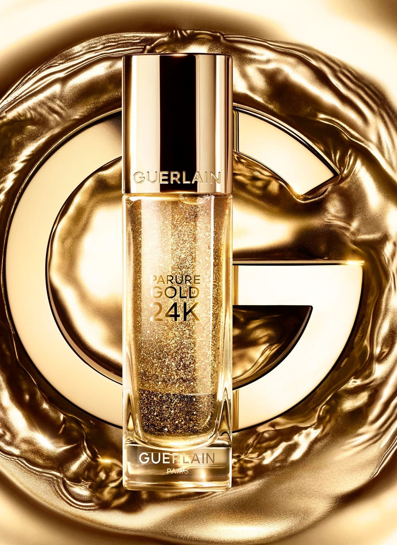 Guerlain Parure Gold 24K Booster. Flacone dorato con particelle dorate. Scritte: Guerlain, Parure Gold 24K.