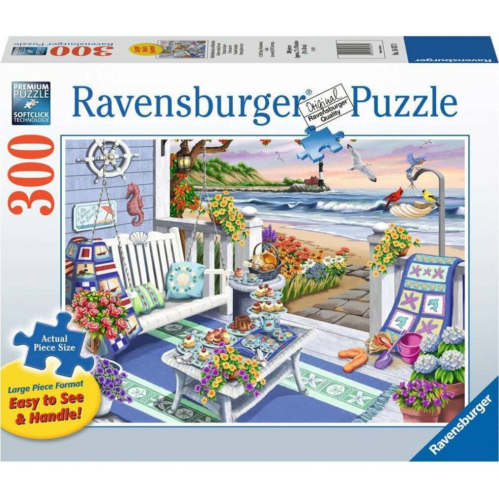 Puzzle Ravensburger, 300 pezzi. Confezione con scena di spiaggia: panchina bianca, tavolo, fiori e mare. Testo: 'Original Puzzle Quality'.