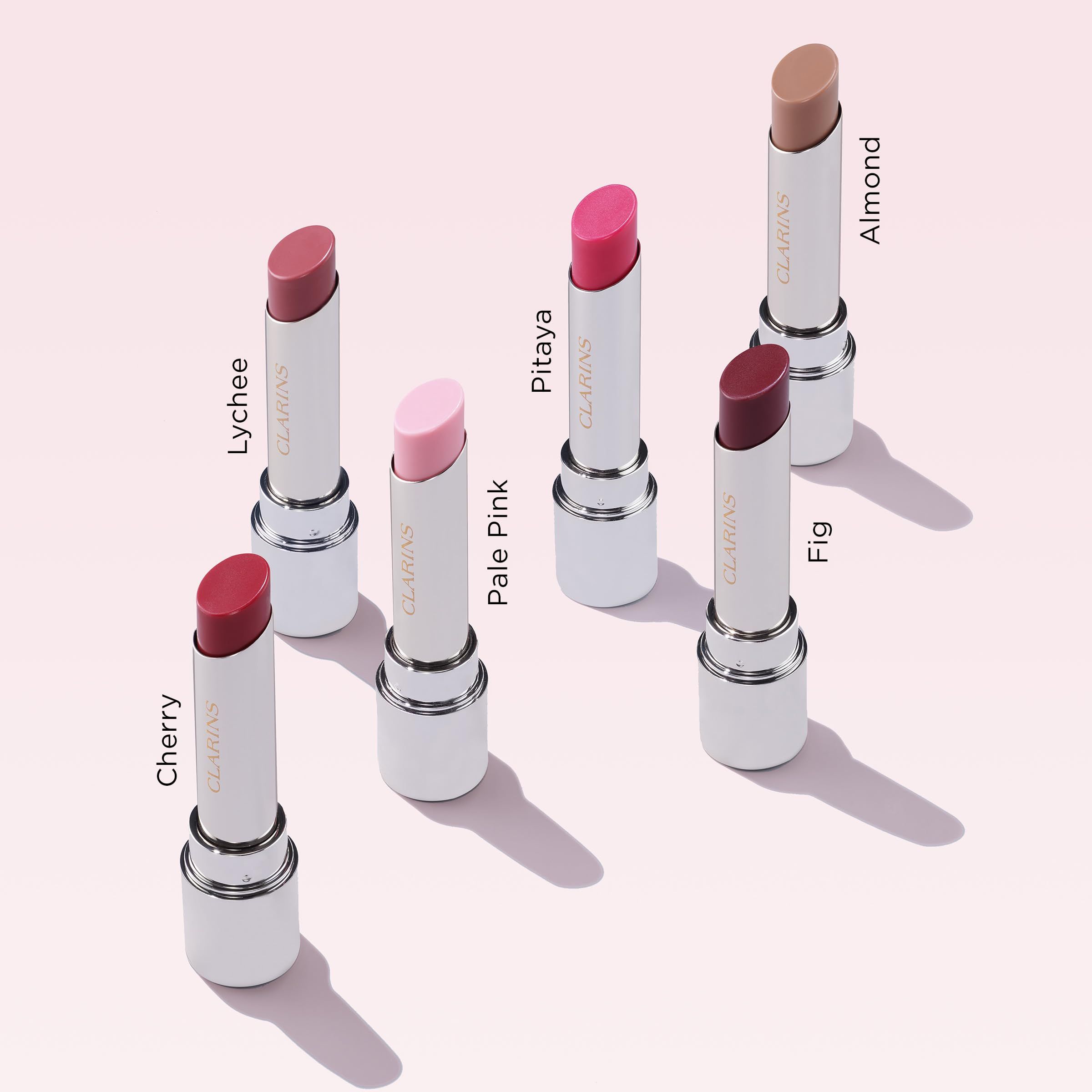 Sette rossetti Lip Oil Balm. Diversi colori. Corpo bianco, base dorata. Scritta.
