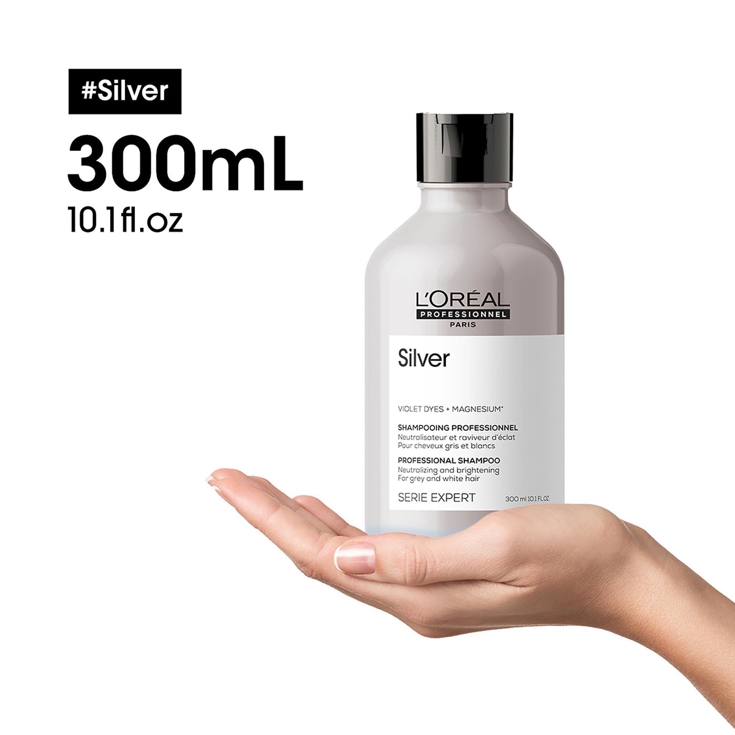 Flacone di shampoo argentato, tenuto in mano. Testo: Silver, L'Oréal Professionnel. 300 ml, 10,1 fl.oz.
