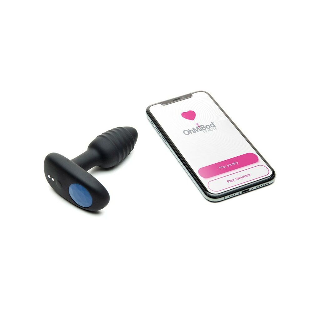Prodotto benessere nero accanto a smartphone. Smartphone mostra interfaccia app con simbolo cuore.