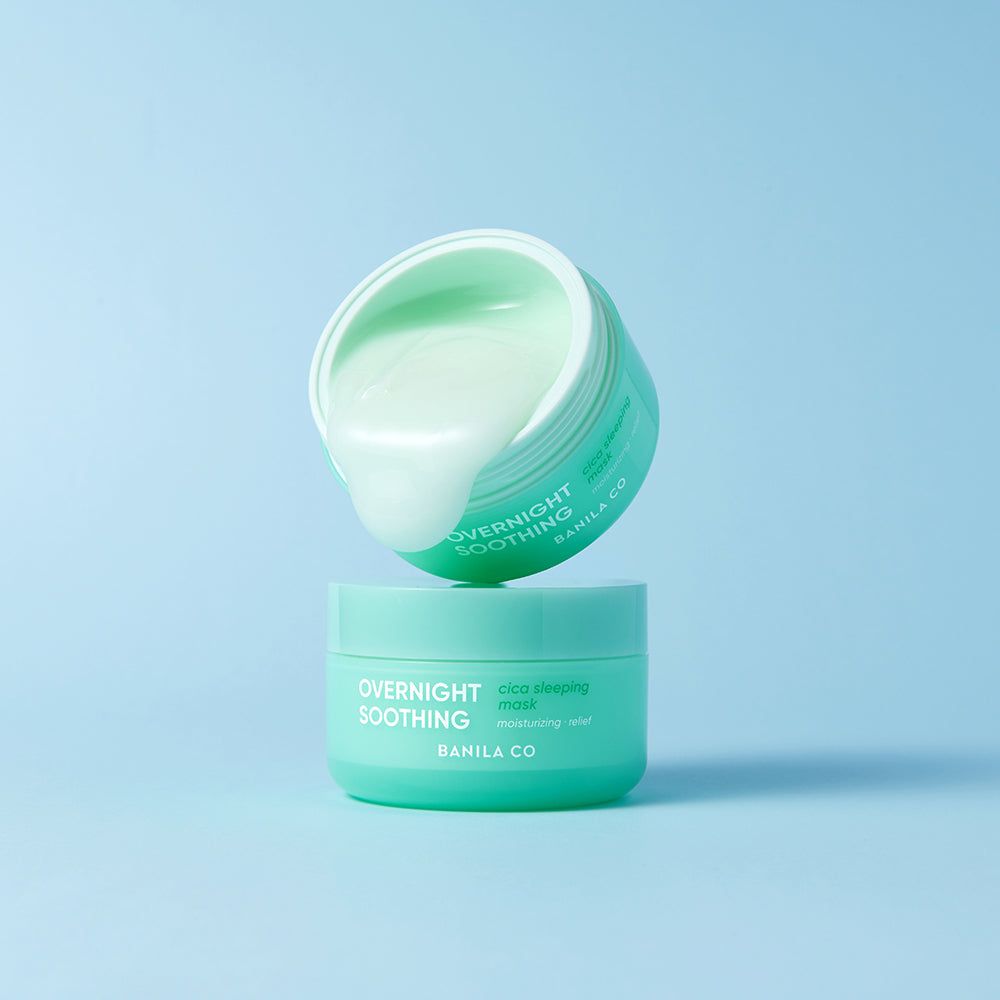 Due vasetti verdi. Uno aperto, con prodotto, l'altro chiuso. Testo: OVERNIGHT SOOTHING, BANILA CO, Cica Sleeping Mask.