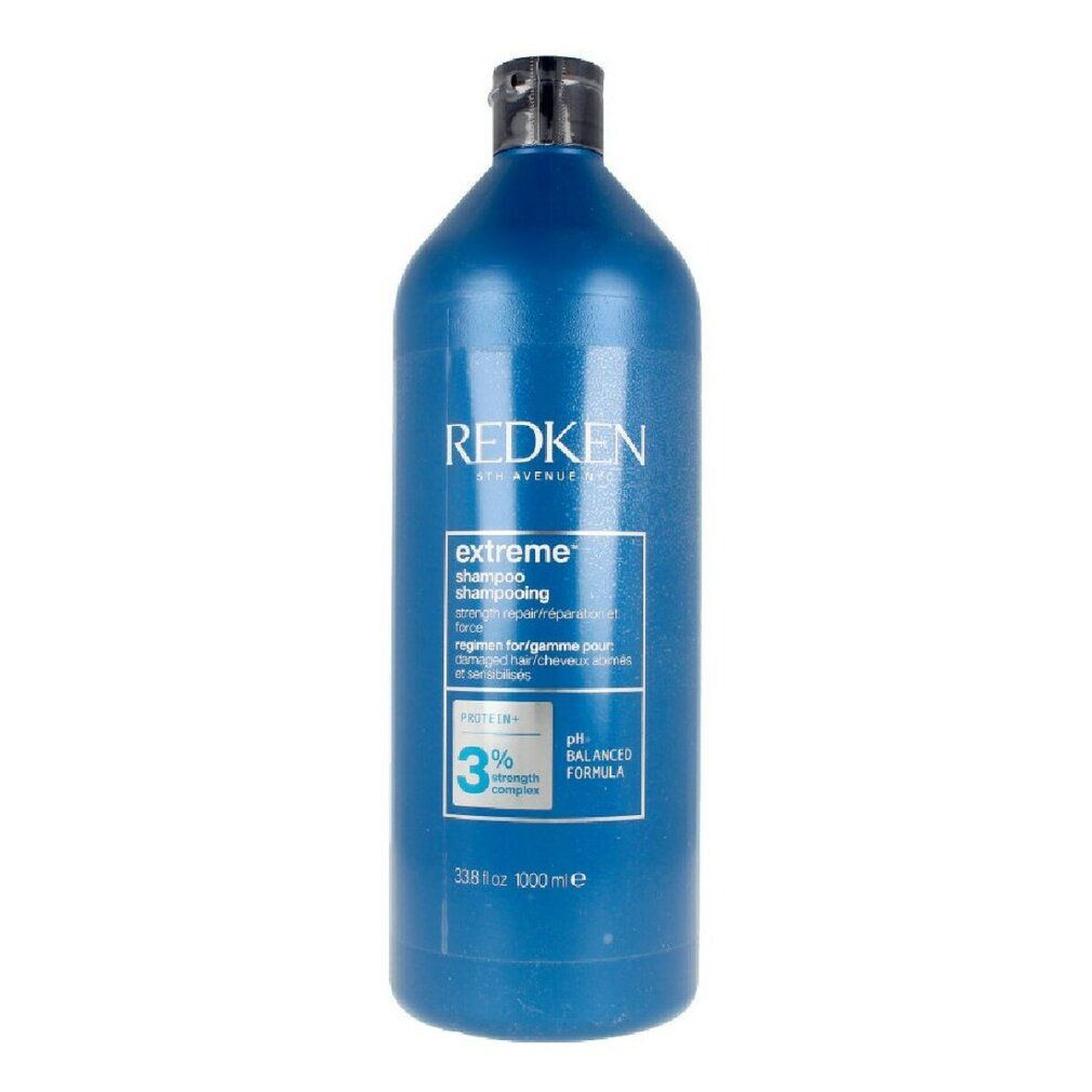 Flacone blu Redken Extreme Shampoo. Tappo nero. Testo: Extreme Shampoo, formula pH bilanciata, 1000 ml.