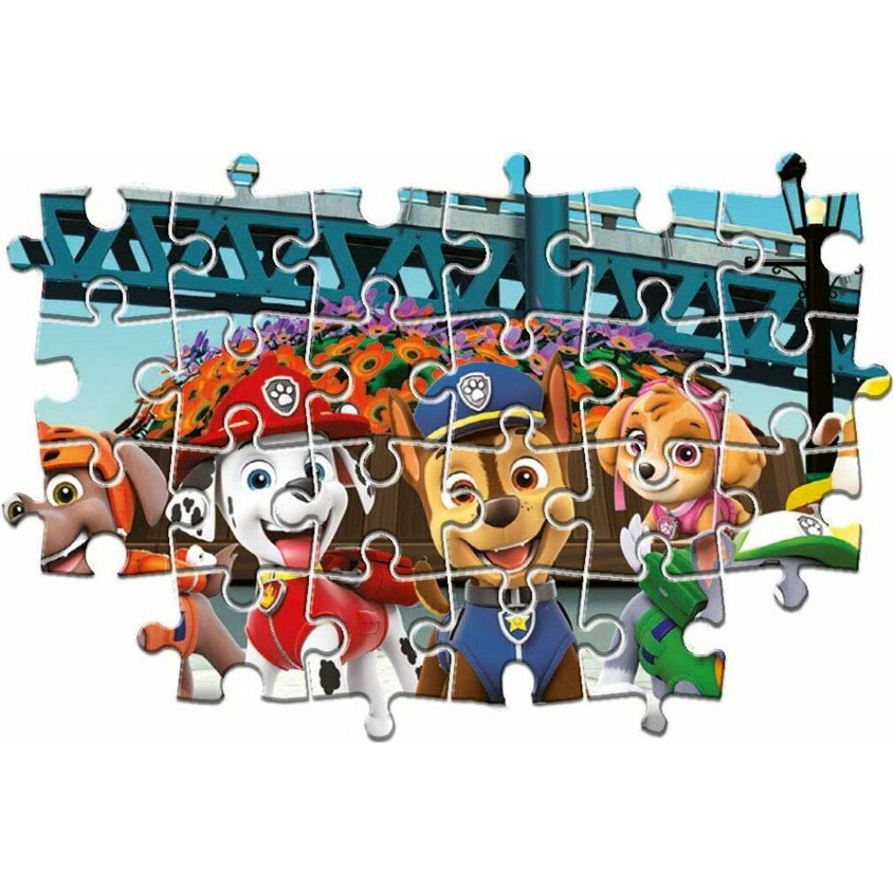 Puzzle Paw Patrol assemblato. Personaggi davanti a ponte e fiori.