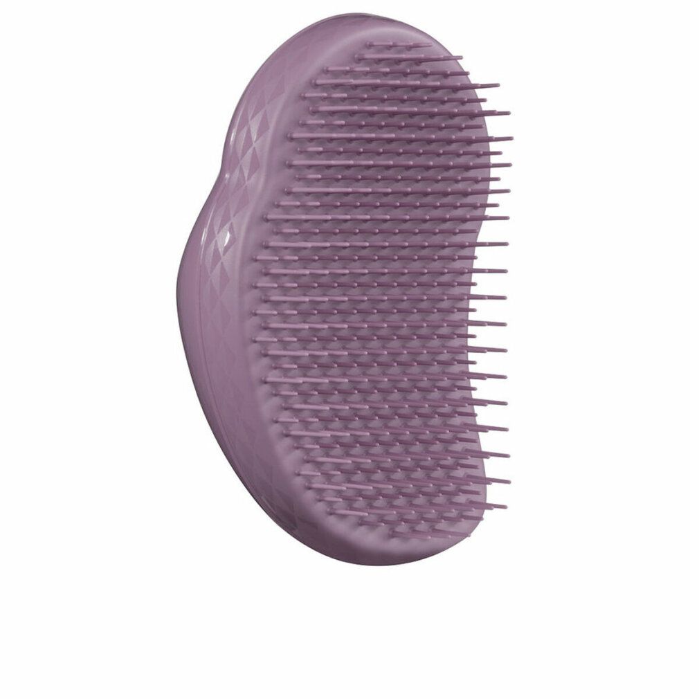 Spazzola per capelli lilla con setole. Forma ergonomica con incavo. Su sfondo bianco.