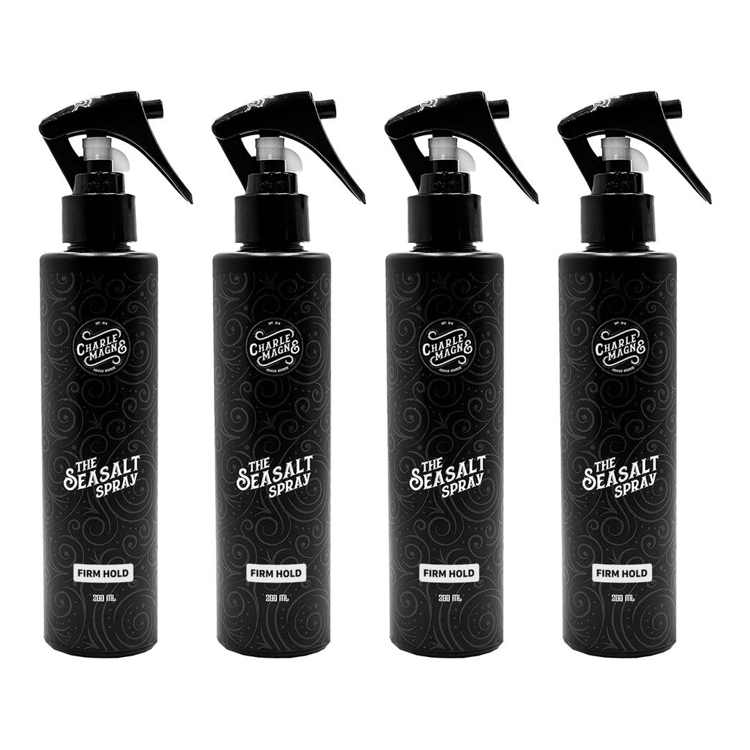 Quattro flaconi spray neri con etichetta "The Seasalt Spray" e "Firm Hold".