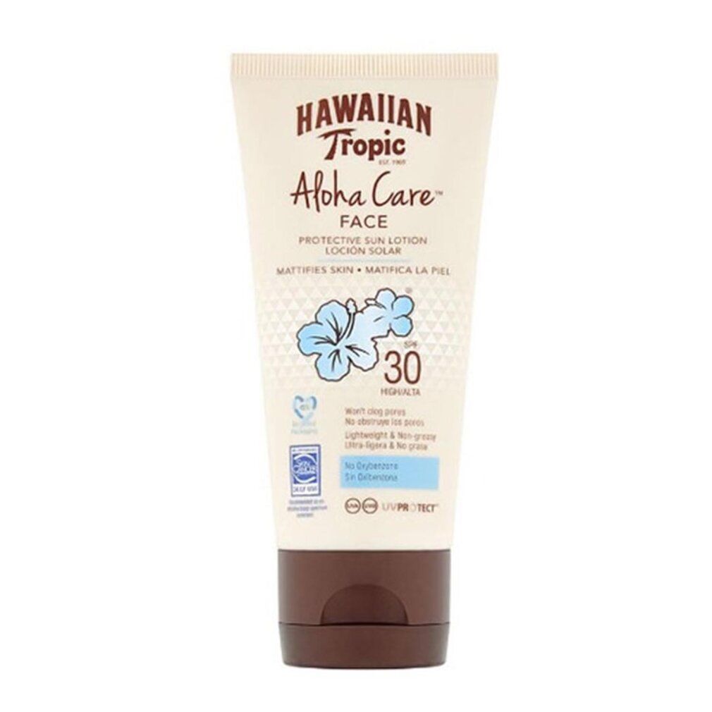 Tubo di lozione solare con tappo marrone. Scritta: Hawaiian Tropic Aloha Care Face SPF30. Fiore blu e testo.