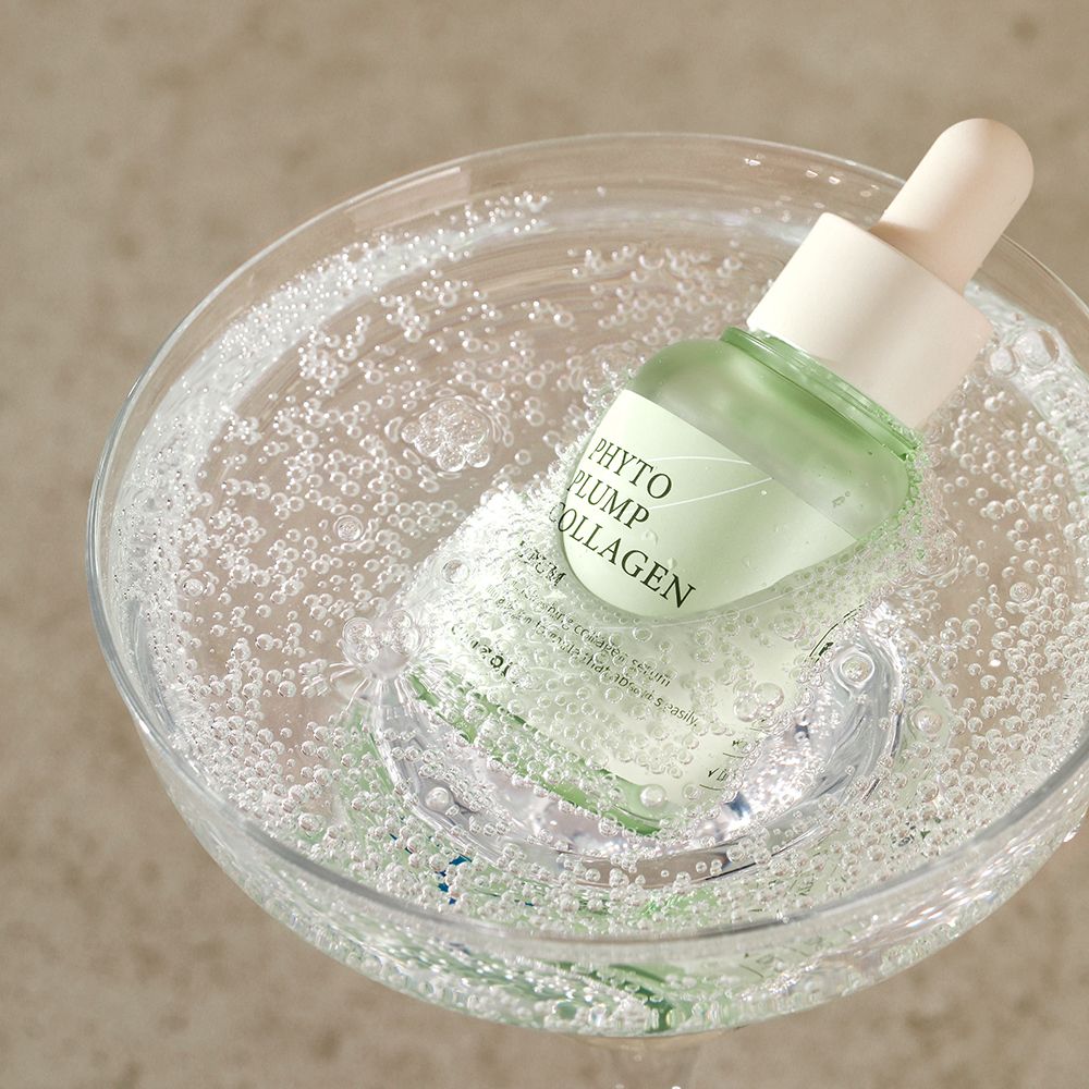 Flacone di siero in un bicchiere con bolle. Nome del prodotto 'Phyto Plump Collagen' visibile.
