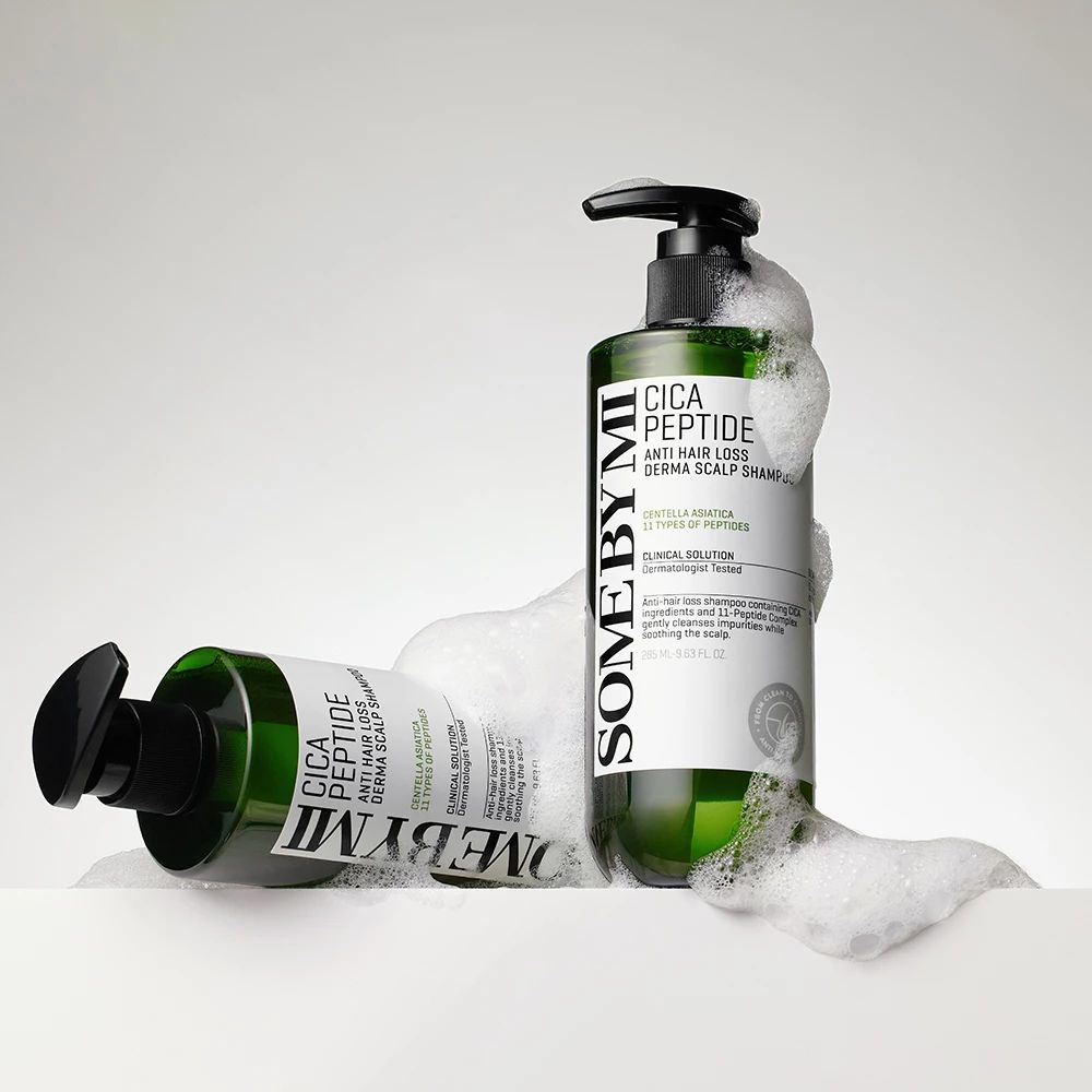 Due flaconi di shampoo verdi con dosatore. Scritta: Cica Peptide Anti Hair Loss Derma Scalp Shampoo. Nella schiuma.